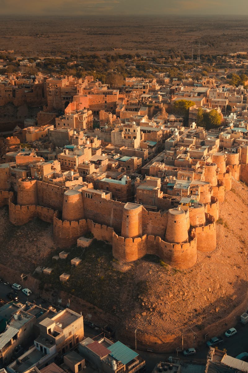 Breathtaking aerial view of the historic Jaisalmer Fort in Rajasthan, India at sunset. A golden monument in the Thar Desert.